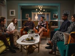 A Jewish and Black family sitting around a coffee table