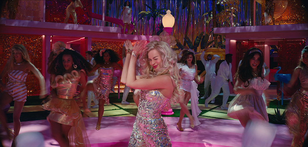 Real-life Blondie Barbie dancing on a dancfloor surrounded by friends