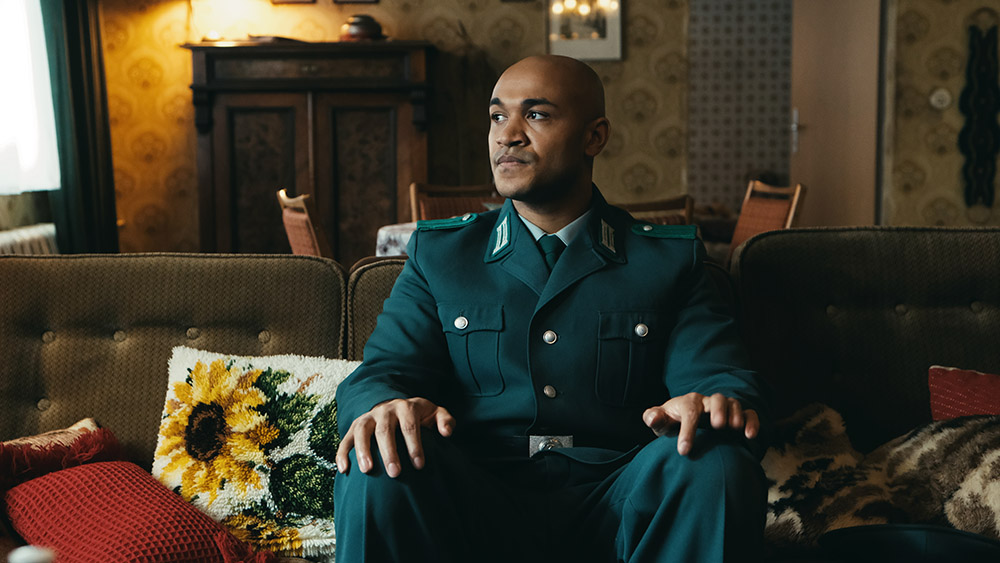 A man sitting on a sofa in a German uniform