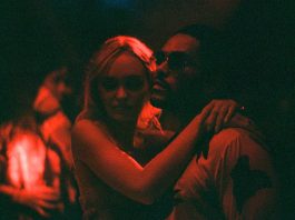 A sexy couple embracing in a club