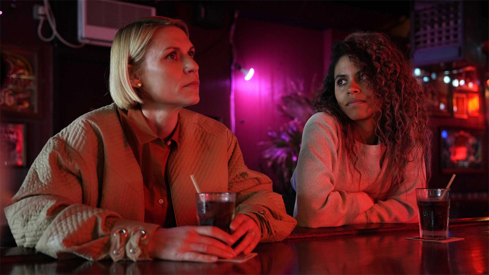 Two women sitting at a bar