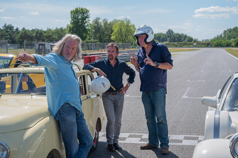 Three old men playing with cars
