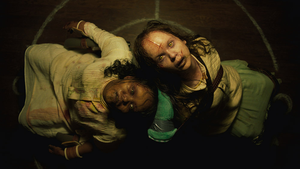 Two young possesed girls staring up at the camera - The Exorcist: Believer