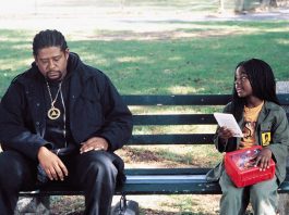 Forest Whitaker sitting on a bench with a young girl - Ghost Dog: The Way of the Samurai