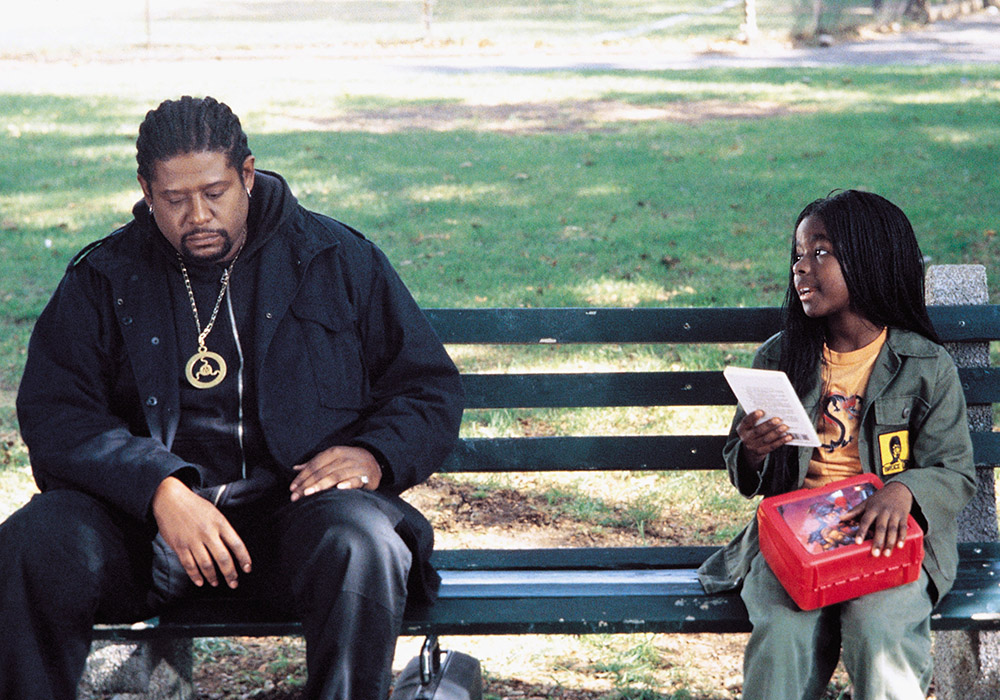 Forest Whitaker sitting on a bench with a young girl - Ghost Dog: The Way of the Samurai
